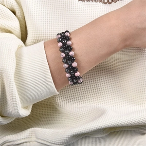 Detail of triple-layer braided bead bracelet with pink marble stones and black hematite