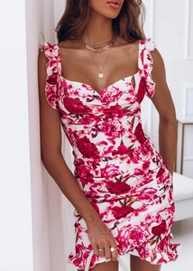 Detail of red rose floral dress featuring ruffle shoulders and pleated hemline finish