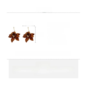 Detailed specs of brown resin flower earrings with gold hooks and silver needle pins