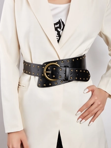 Detail of black wide waist belt with golden round rivets and large buckle on white blazer