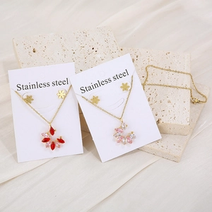 Detailed macro view of gold-plated stainless steel floral necklace and earring jewelry sets