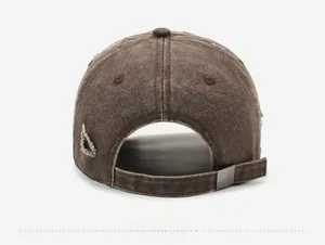 Detail view of the vintage distressed brown baseball cap with adjustable metal buckle