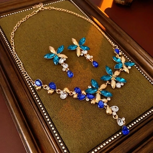Vintage gold jewelry set with blue floral crystal necklace and teardrop earrings