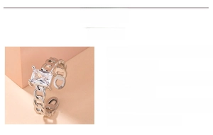 Detail of silver chain band ring with large rectangular white zircon in four-prong setting