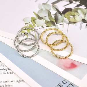 Detail of minimalist beaded stackable rings in gold and silver finish set of six