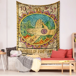 Detail of bohemian Wheel of Fortune tarot tapestry hanging on a cozy bedroom wall