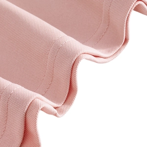 Macro shot of pink fabric texture showing fine knit pattern and double stitching details