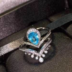 Elegant crown stackable ring set with pear-cut aquamarine gemstone and white pearls