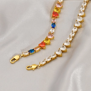 Gold tennis chain bracelet with multi-color heart zircons on luxury silk background