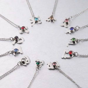 Collection of silver stainless steel zodiac necklaces with colorful birthstone crystals
