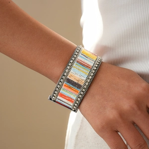 Close-up of Bohemian wide cuff bracelet with colorful patterns and crystal border