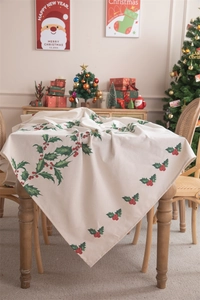 Festive Christmas tablecloth with red berries and green leaf prints on beige fabric