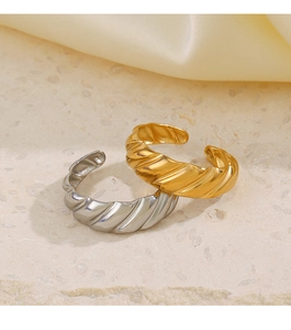 Detail of adjustable croissant style rings in gold and silver finish on stone