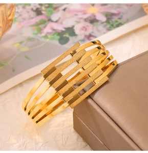 Close-up of gold-plated geometric bracelet with matte and polished contrast on display