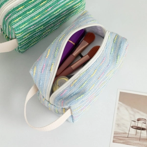 Minimalist woven large capacity toiletry bag in green and blue with striped texture
