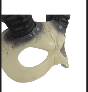 Macro shot of white devil mask showing realistic bone texture and black horns details