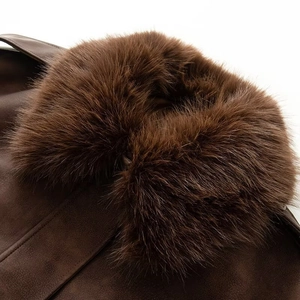 Detailed close-up of high-quality faux fur collar and dark brown suede texture jacket
