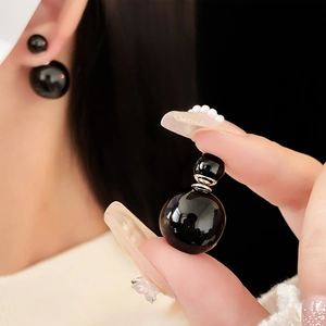 Minimalist double-pearl stud earrings in glossy black finish with silver connectors