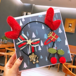 Detail of Christmas headband with plush red reindeer antlers and matching hair clip set