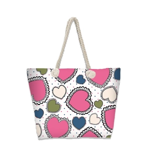 Detail of colorful heart pattern on beach tote with nautical cotton rope handles