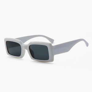 Detail view of white rectangular sunglasses featuring thick frames and wide temples