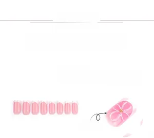 Detail of pink blush press-on nails with 3D white flowers and French tips