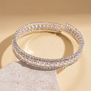 Detail of multi-layer silver bracelet with faux pearls and sparkling crystal rhinestones