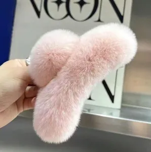 Detail of pink faux fur claw clip featuring soft plush texture and curved design