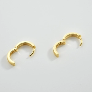Detail view of gold S925 sterling silver huggie earrings showing the hinge opening mechanism
