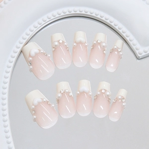 Short ballet press-on nails with white pearls, sparkly rhinestones and cream hearts