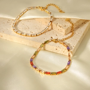 Detail of 18K gold stainless steel bracelets with clear and colored zircon crystals