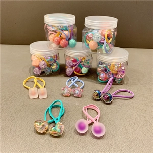 Macro shot of colorful heart and star shaped elastic hair bands in clear storage jars