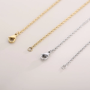 Detail of 18K gold and silver stainless steel O-chains with secure lobster clasps