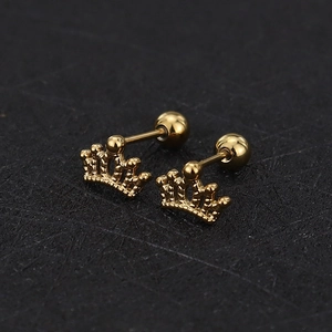 Macro detail of gold crown stud earrings with screw ball back in polished titanium steel