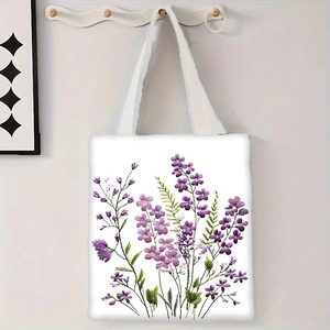 Détail du sac cabas en toile blanche avec motif floral violet et poignée robuste