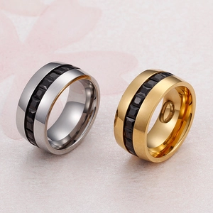Silver and gold wide zircon rings with black faceted inlay on light marble background