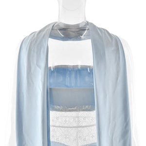 Detail of light blue satin dress featuring halter neck straps and white lace patchwork