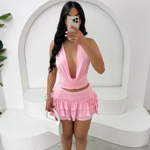 Detail of pink halter neck set with draped top and layered ruffle mini skirt