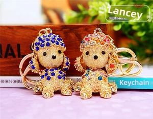 Detail of blue and colorful rhinestone puppy keychains with gold-toned alloy base