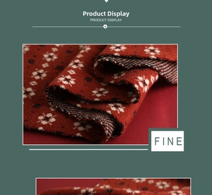 Close-up of red knitted scarf with white snowflake pattern and ribbed texture detail