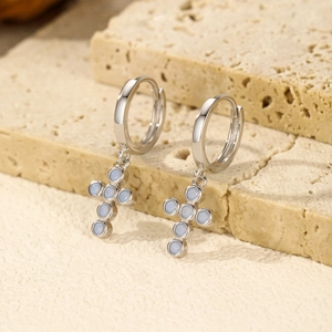 Elegant s925 silver cross earrings featuring light blue opal stones on stone background