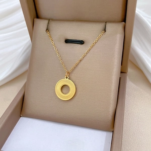Minimalist gold titanium steel necklace with rotating sunray textured ring pendant