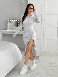 Detail of grey ribbed knit dress featuring elegant ruffle trim and side slit design