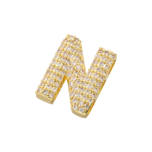 Macro view of gold-plated letter N pendant featuring clear cubic zirconia pavé