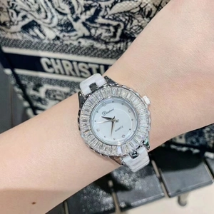 Elegant ladies quartz watch with crystal bezel and white ceramic band worn on wrist