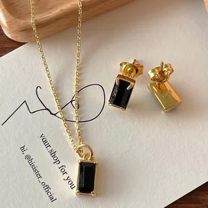 Detailed close-up of S925 hallmark on gold-plated stud earrings with black stones
