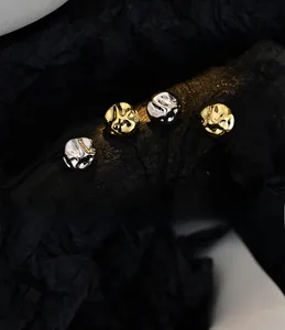 Macro detail of S925 silver irregular lava earrings in gold and silver finish