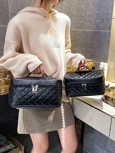 Quilted black leather cosmetic bags with top handles and double zippers for travel
