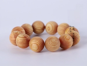 Close-up of sandalwood beads showing natural wood grain and polished texture