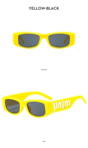 Detail view of yellow rectangular sunglasses with palm metal decor and dark lenses